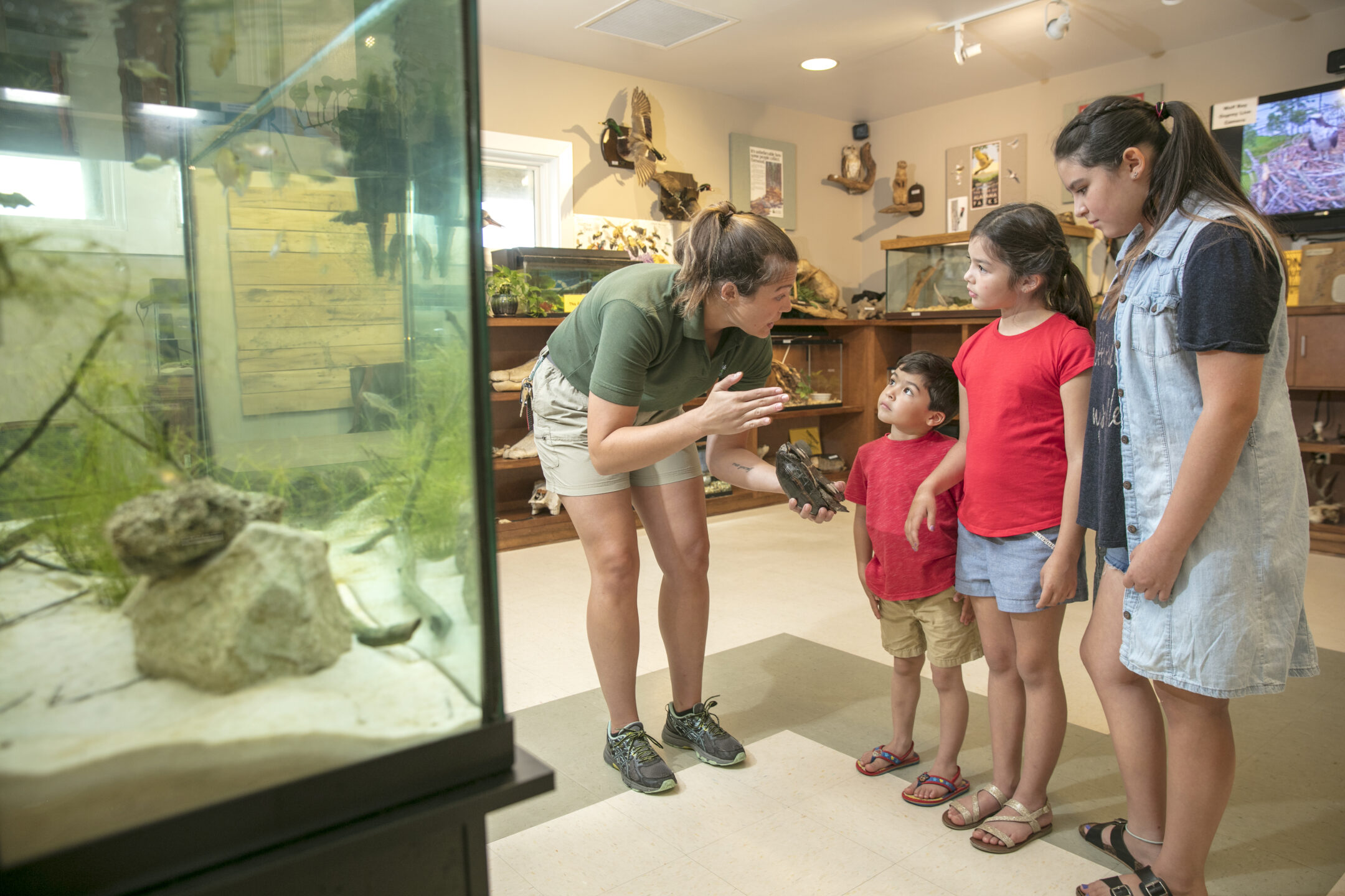 Naturalist at the Nature Center at Gulf State Park shares information about local wildlife with young visitors